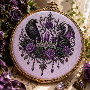 May include: A circular embroidery hoop containing a cross-stitch design on light purple fabric. The pattern features a black raven, a dragon, a central crystal, a crown, and purple roses. The hoop is encased in an ornate, antique gold frame.
