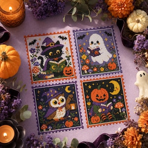 May include: A cross-stitch pattern on light purple fabric featuring four rectangular panels with Halloween themes: a black cat in a witch hat reading a book, a white ghost reading, an owl with a lantern, and a jack-o'-lantern reading a book.