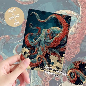 May include: A rectangular print featuring a detailed illustration of a large octopus with red tentacles and a blue body, set against a dark background with stylized waves. The print includes text that reads Matte & Non Foil & Foil and high-definition and clear.