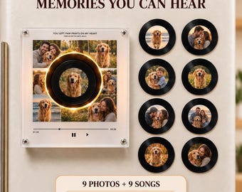 May include: A square acrylic photo display featuring the text "MEMORIES YOU CAN HEAR" and "YOU LEFT PAW PRINTS ON MY HEART," with a central circular light and eight small circular black vinyl record magnets, each displaying a different dog photo.