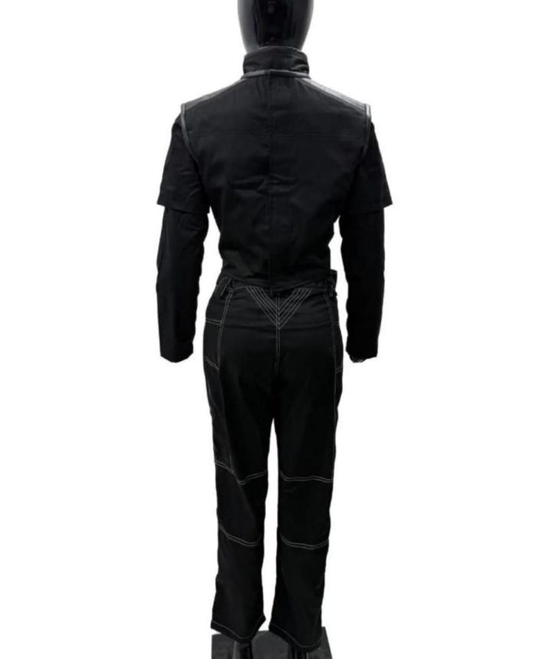May include: A black jumpsuit featuring a high collar, long sleeves, and a structured bodice. The pants portion includes prominent white contrast stitching along the seams, a V-shaped waist detail, and horizontal stitching lines across the legs.