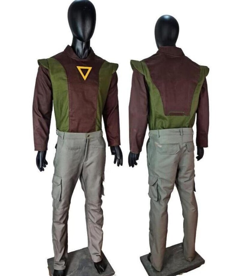 May include: A two-piece outfit consisting of a long-sleeved shirt and cargo pants. The shirt features a brown and olive green color-blocked design with a yellow triangle emblem on the chest. The pants are light gray with side cargo pockets.