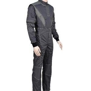 May include: A dark gray jumpsuit featuring a high collar, long sleeves with black ribbed cuffs, and white contrast stitching throughout. The garment includes geometric patterned panels on the shoulders and sleeves, with a fitted waistline.
