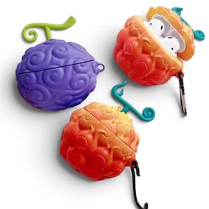 May include: Three silicone earbud cases shaped like stylised fruits with swirling patterns. One case is solid purple with a green stem, while two are orange and red gradients with teal stems. One orange case is open, revealing white earbuds inside.