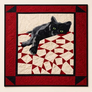 May include: A square wall quilt featuring a geometric black cat with bright green eyes resting on a cream and red patterned surface. The central image is framed by a wide, textured red border with black corner accents and intricate stitching.