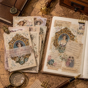 May include: A collection of vintage-style paper ephemera featuring ornate gold frames, floral illustrations, and portraits of people. The set includes rectangular cards and a journal page with script text, postage stamps, and decorative paper clips.