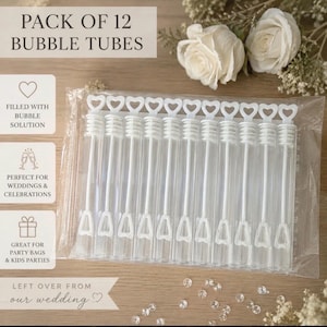 May include: A pack of 12 clear plastic bubble tubes, each featuring a white wand with a heart-shaped handle. The tubes are sealed in a transparent plastic bag. Text on the image reads: PACK OF 12 BUBBLE TUBES, FILLED WITH BUBBLE SOLUTION, PERFECT FOR WEDDINGS & CELEBRATIONS, GREAT FOR PARTY BAGS & KIDS PARTIES, LEFT OVER FROM our wedding.