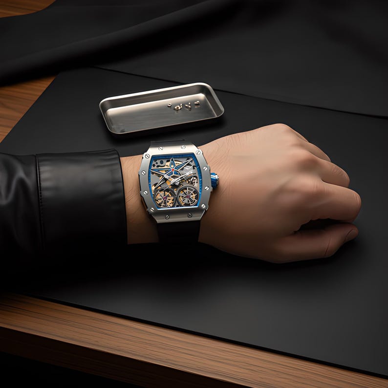May include: A silver-toned tonneau-shaped wristwatch with a skeletonized dial, blue accents, and a black strap. The watch features visible internal gears and a star-shaped element on the face. A small metal tray with tiny screws sits nearby.