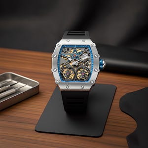 May include: A silver-toned tonneau-shaped wristwatch featuring a skeletonized dial with a prominent blue star motif, dual exposed balance wheels, and a black rubber strap. The watch case is secured with eight visible screws and includes a blue crown.