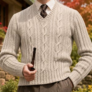 May include: A beige V-neck jumper featuring a vertical cable knit pattern, worn over a white collared shirt with a dark brown patterned necktie. The jumper has ribbed cuffs and a ribbed hem, and is paired with dark brown trousers.