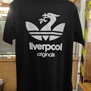 Black cotton t-shirt reflecting the dark, moody colour palette of college basketball rivalry merchandise