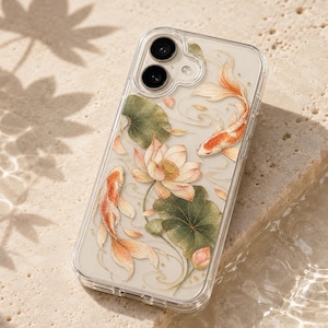May include: A clear smartphone case featuring a detailed illustration of two orange and white koi fish swimming among pink lotus flowers and green lily pads. The design includes delicate gold accents and flowing water lines on a transparent background.