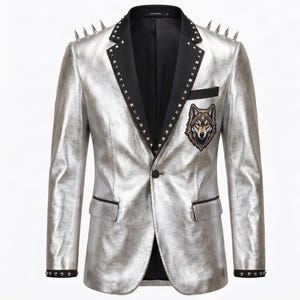 May include: A metallic silver blazer featuring black lapels with silver studs, silver spikes on the shoulders, and a wolf head patch on the chest. The jacket includes a single button closure, two flap pockets, and black trim on the cuffs and pockets.