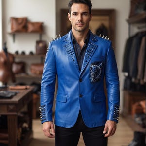 May include: A vibrant blue leather blazer featuring silver metal spikes on the shoulders and cuffs, black pyramid studs along the lapels, and a graphic print of a howling wolf surrounded by lightning on the left chest pocket area.