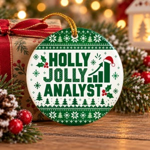 May include: A round white ceramic Christmas ornament with a green border featuring a repeating snowflake and tree pattern. The centre text reads HOLLY JOLLY ANALYST in green, accompanied by a green bar chart graphic topped with a red Santa hat.