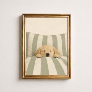 May include: A framed wall art print featuring a light golden puppy sleeping with its head resting on its paws. The puppy is positioned against a background of soft sage green and white vertical stripes, enclosed in a metallic gold frame.