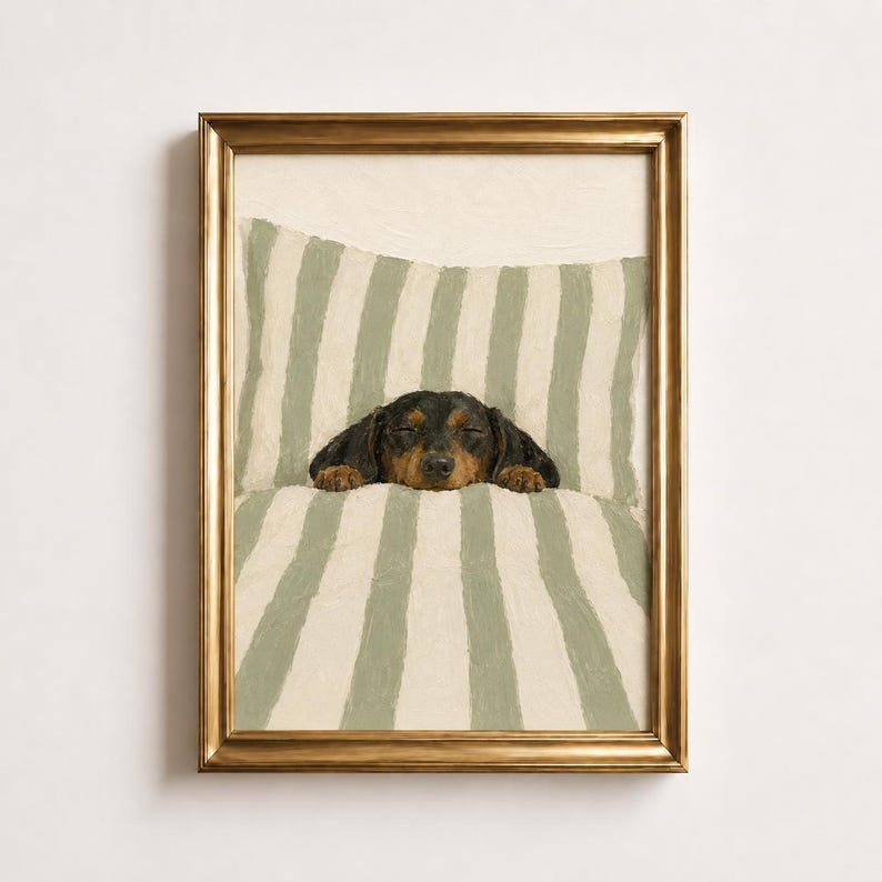 In this poster, you can see a black and tan dachshund sleeping under a sage green and cream striped duvet with its paws poking out.