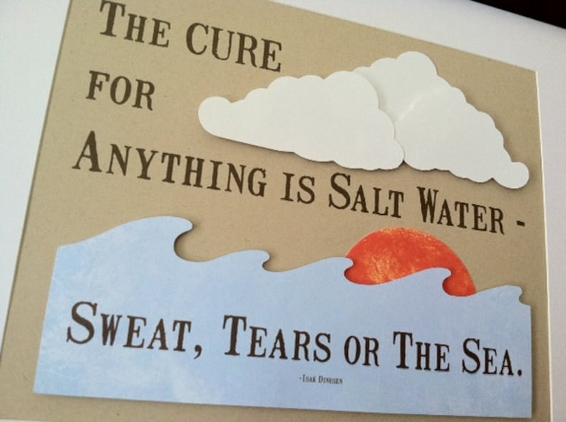 May include: A brown paper background with a white paper cutout of clouds and waves. The text reads "The cure for anything is salt water - sweat, tears or the sea."  The text is attributed to Isak Dinesen.