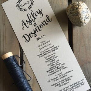 May include: A wedding ceremony program printed on brown paper with black ink. The program includes the names Ashley and Desmond, the date 10-15-16, and the location Waco, TX. The program lists the order of events for the ceremony, including the processional, readings, vows, and recessional. The program also includes a quote from Song of Solomon 8:6.