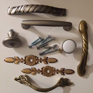 May include: Assortment of cabinet hardware in gold and silver finishes. Includes drawer pulls, knobs, and decorative pulls.