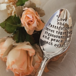 May include: A silver spoon with a quote engraved on it that reads "Love and faithfulness meet together, righteousness and peace kiss each other."