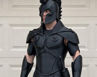 May include: A full-body matte black Spartan-style armour set featuring a crested helmet with a face guard, a chest plate with circular emblems, shoulder pauldrons, arm bracers, a tasset skirt, leg greaves, and a sword sheathed at the left hip.