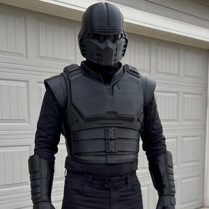 May include: A full-body black tactical costume featuring a rigid helmet with a face mask, a structured chest plate, matching arm guards, gloves, and leg armor with knee pads. The ensemble is completed with black trousers and boots for a uniform look.