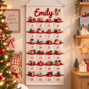 May include: A white fabric Christmas advent calendar hanging from a wooden rod, featuring the name Emily in red script at the top. It has twenty-four numbered pockets, each containing small festive ornaments like reindeer, stars, and gifts.