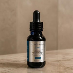 May include: A dark blue glass dropper bottle of SkinCeuticals P-TIOX wrinkle-modulating peptide serum. The silver label features black text, a blue accent bar with the word CORRECT, and clearly displays the volume as 15 ml / 0.5 fl oz.