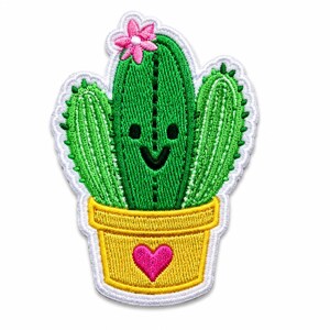 May include: An embroidered patch featuring a green cactus with a smiling face and a pink flower on top. The cactus is planted in a yellow pot decorated with a pink heart. The entire design is outlined with a white border and has a textured finish.