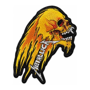 May include: An embroidered patch featuring a yellow and orange skull with a flaming effect. The skull has an open mouth with visible teeth. The word Metallica is written in white stylised letters across the lower portion of the design.