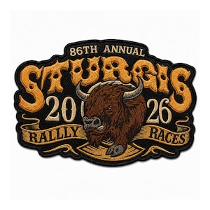 May include: An embroidered patch featuring a central brown bison illustration. The text reads 86TH ANNUAL STURGIS 2026 RALLY RACES in gold and cream thread against a black background. The design includes a decorative ribbon banner at the bottom.