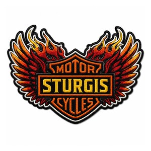 May include: An embroidered patch featuring a central shield with the text MOTOR STURGIS CYCLES in yellow and orange. The shield is flanked by two large, detailed wings with red, orange, and yellow flame patterns, all outlined in black and white thread.