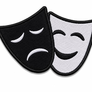May include: Two embroidered theater masks featuring a black mask with white stitching for a sad expression and a white mask with black stitching for a happy expression. Both masks have thick black borders and are positioned overlapping each other.