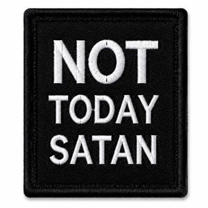 May include: A rectangular black embroidered patch with a stitched border. The text NOT TODAY SATAN is displayed in white capital letters across the centre of the patch. The design features a clean, high-contrast look with white thread on black fabric.