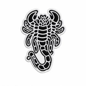 May include: An embroidered patch featuring a stylized scorpion design. The scorpion is rendered in high-contrast black and white thread, with a detailed segmented body, pincers, and a curved tail. The entire shape is outlined in white stitching.