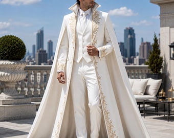 May include: A white floor-length cape coat featuring gold embroidery along the lapels and cuffs, worn over a matching white vest, dress shirt, and trousers. The ensemble includes a high collar and a structured, full-length silhouette.