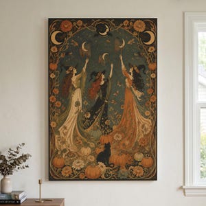 May include: A rectangular wall art print featuring three figures in pointed hats and long flowing gowns standing among pumpkins and flowers. They reach toward crescent moons in a dark teal sky. A black cat sits among the orange pumpkins.