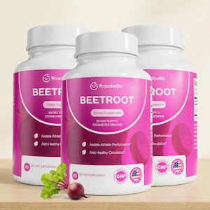 May include: Three white plastic bottles of Rosabella Beetroot dietary supplement with pink labels. Each bottle features the text 30 Day Supply 1300mg Per Serving, Assists Athletic Performance, and Aids Healthy Circulation. A fresh beetroot sits in front.