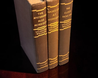 May include: Three brown hardcover books by Valentine Williams titled The Mysterious Miss Morrisot, Masks of Midnight, and The Clock Ticks On. Each spine features gold lettering and the publisher name Collier printed near the bottom edge.
