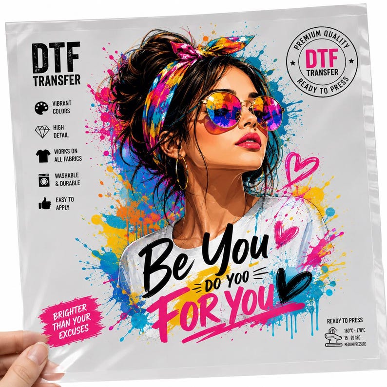 May include: A DTF transfer sheet featuring a colorful illustration of a person with a messy bun, a vibrant headband, and round sunglasses. The text reads Be You Do You For You and Brighter Than Your Excuses, surrounded by paint splatters and hearts.