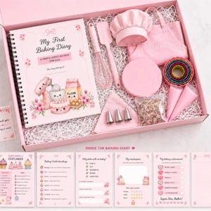 May include: A pink gift box containing a spiral-bound My First Baking Diary, a pink chef hat, a pink apron, a whisk, a spatula, a round cake board, colourful cookie cutters, piping bags, metal piping tips, and a bag of rainbow sprinkles.