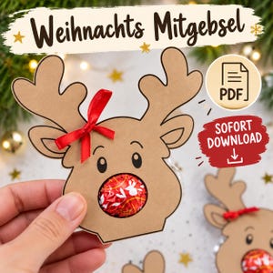 Peut inclure: Une découpe de renne en papier cartonné beige avec un nœud en ruban rouge et une ouverture circulaire pour un chocolat emballé dans du papier rouge. L'image contient le texte "Weihnachts Mitgebsel", une icône PDF et un graphique rouge "SOFORT DOWNLOAD".