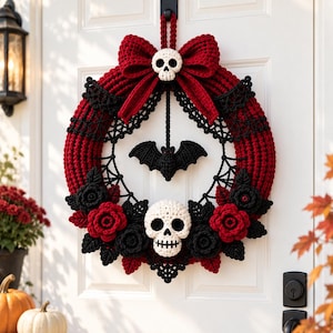 May include: A circular crochet wreath featuring a deep red yarn base, a large red bow at the top, and a white skull center. The design includes black crocheted roses, black leaves, a black spiderweb pattern, and a hanging black bat ornament.