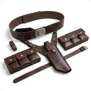 May include: A dark brown leather utility belt system featuring a wide main belt with a metallic buckle, a shoulder harness, two triple-pouch sets with gold-tone snap closures, and a holster. The components are connected by black metal hardware.