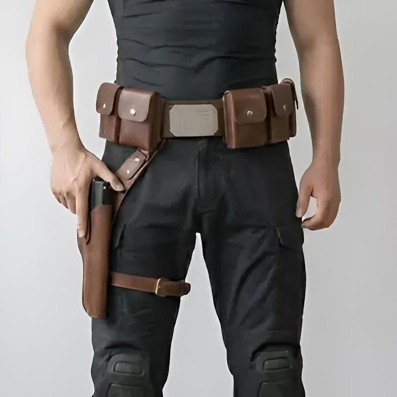 May include: A brown leather utility belt featuring four rectangular pouches with metal snap closures, a central metallic buckle plate, and an integrated drop-leg holster with a buckled thigh strap, worn over black tactical trousers and a black shirt.
