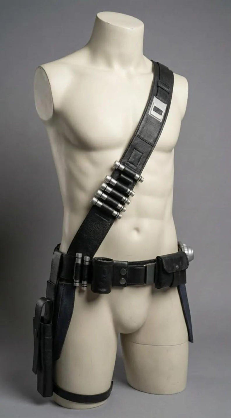 May include: A black leather utility belt and shoulder strap set featuring silver-toned cylindrical canisters attached to the strap and belt. The gear includes multiple pouches, a holster, and a metallic buckle, all displayed on a neutral mannequin torso.