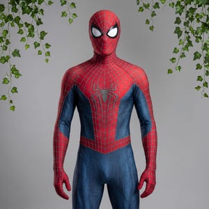 May include: A full-body superhero costume featuring a red and blue textured fabric. The red sections have a black web pattern, while the blue sections have a subtle lined texture. A large black spider emblem is centered on the chest area.