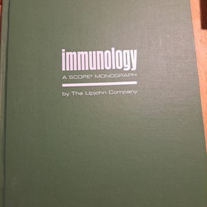 May include: A green book with the title "Immunology" and the text "A SCOPE Monograph by The Upjohn Company".