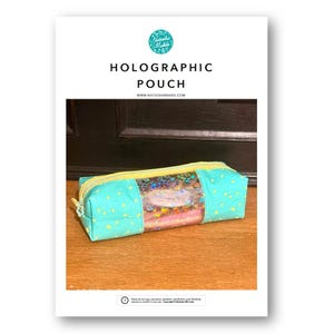 May include: A rectangular pouch with a teal fabric exterior featuring a yellow star pattern. The centre section is a clear holographic window filled with colourful confetti. It includes a yellow zip closure along the top edge.